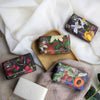 Various soaps with decorative packaging on a white surface