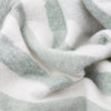 Beechwood Throw Moorland Green Close-up of soft, textured fabric in white and gray tones.