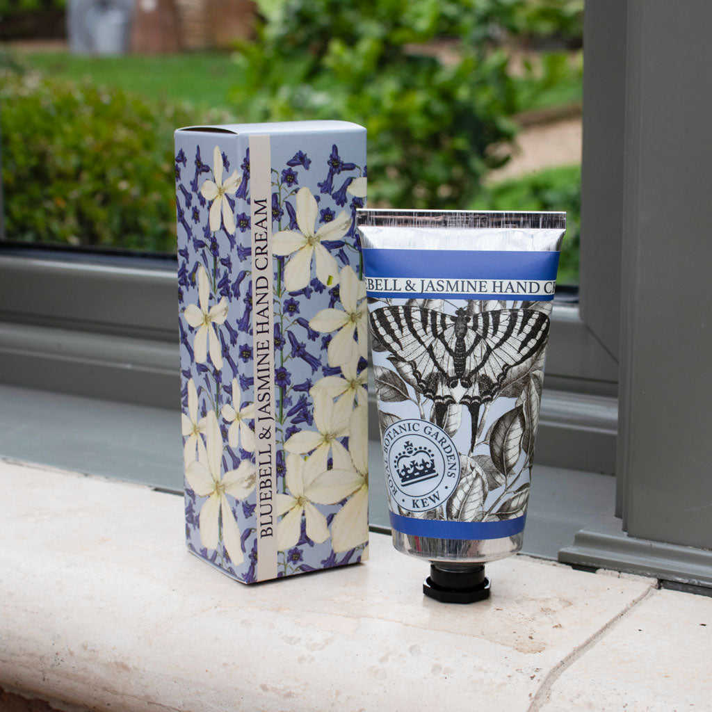 Hand cream packaging with floral design on a neutral background