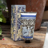 Bluebell & Jasmine hand cream and packaging on a wooden surface with plants in the background