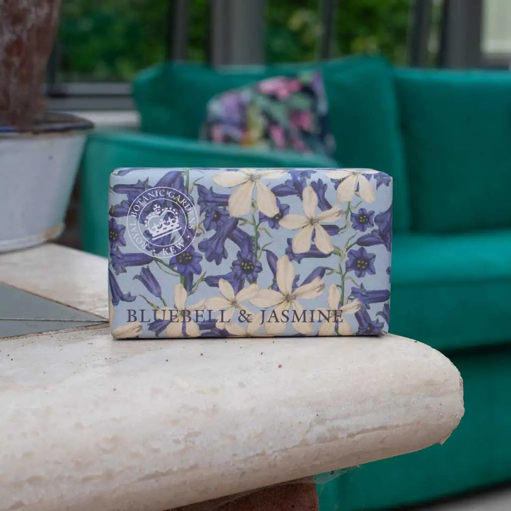 Bar of soap with floral design and 'Bluebell & Jasmine' text on a stone surface.
