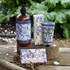 Bluebell & Jasmine hand care products including hand wash, hand cream, and soap on a wooden surface with greenery in the background.