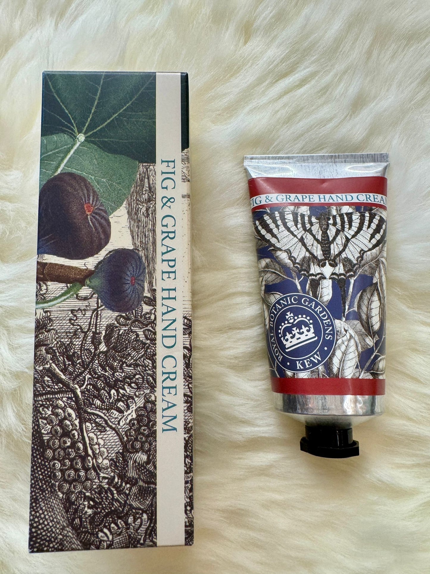 Fig & Grape hand cream with packaging on a fluffy white surface