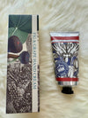 Fig & Grape hand cream with packaging on a fluffy white surface