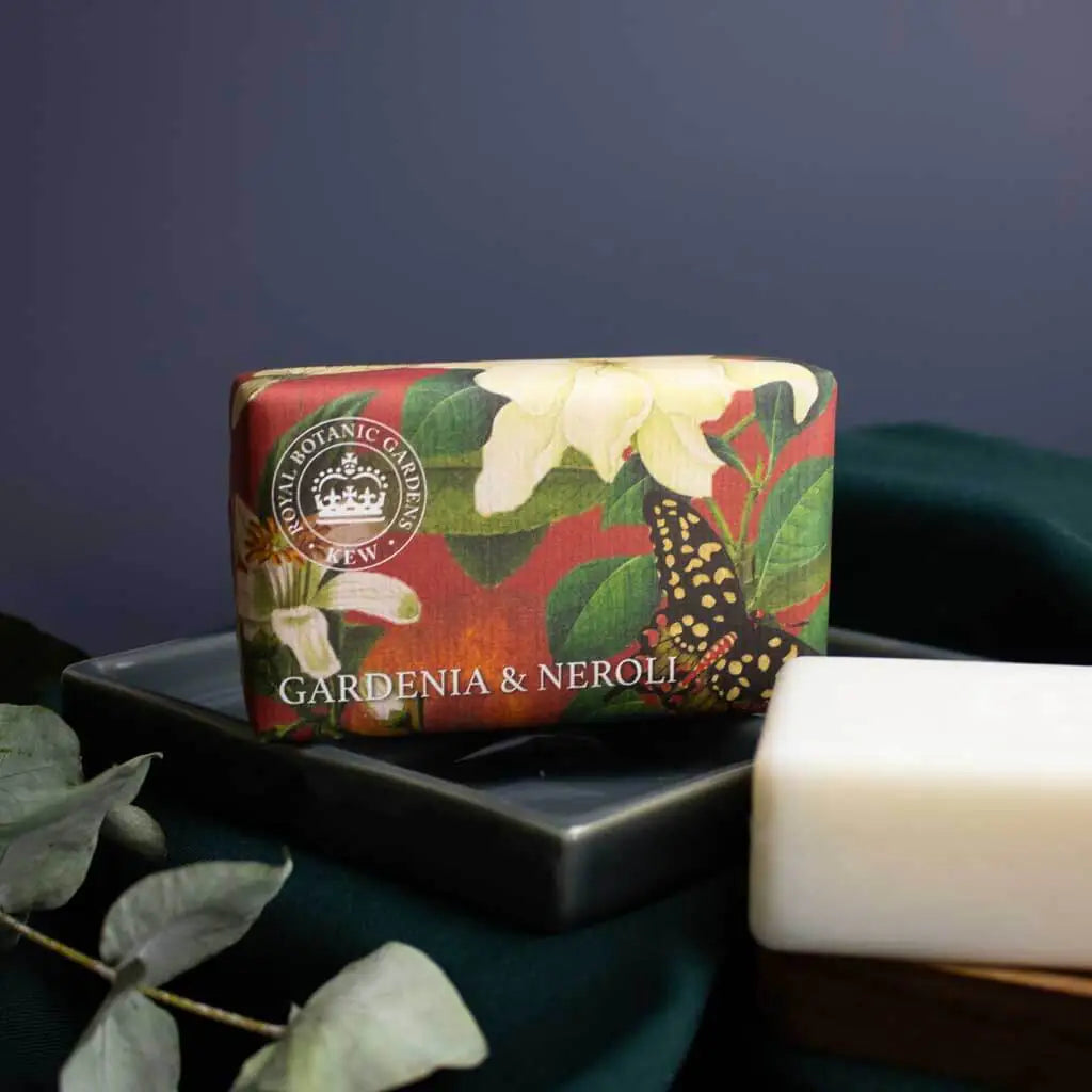 Bar of soap with 'Gardenia & Neroli' packaging on a dark surface