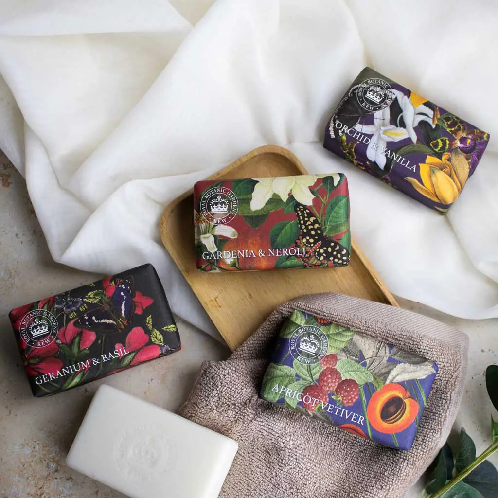 Various soaps with decorative packaging on a white surface