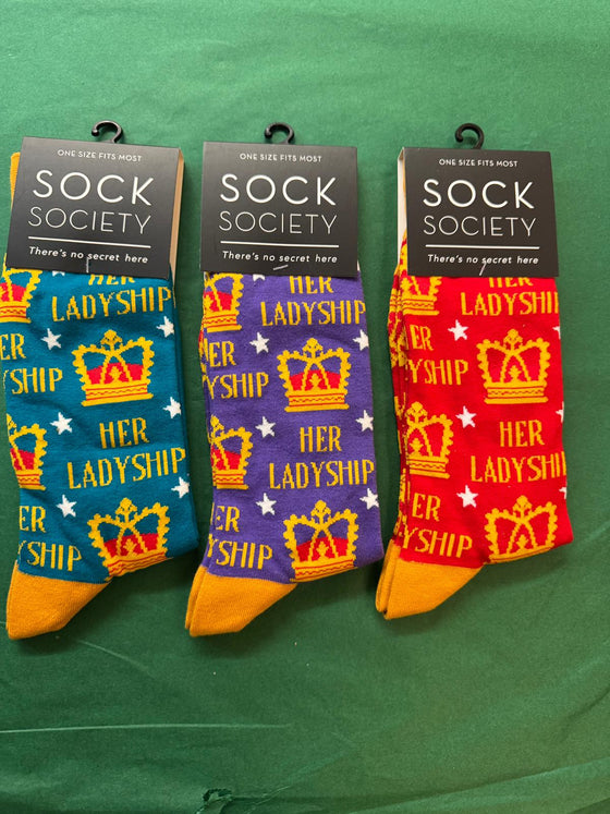 Three pairs of socks with 'Her Ladyship' design in blue, purple, and red packaging on a green background.