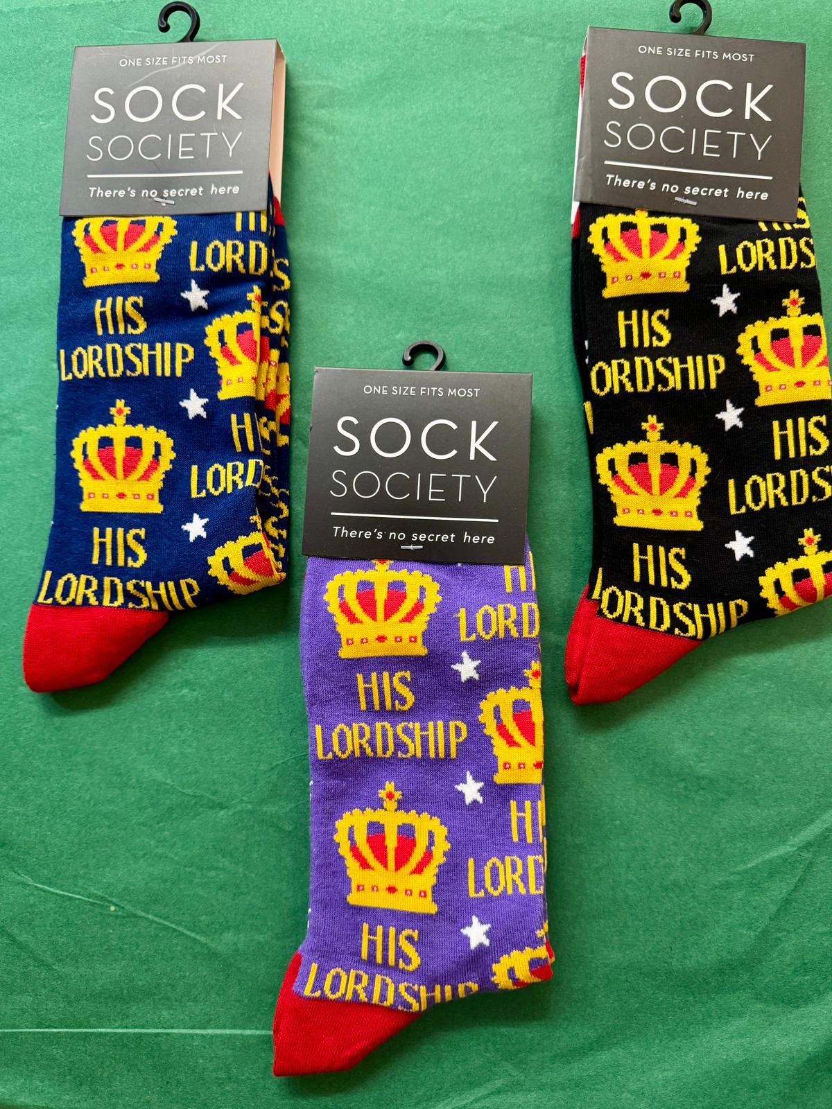 Three pairs of socks with 'LORDS HIS LORDSHIP' text and crowns on a green background, branded as Sock Society.
