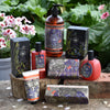 Collection of Lavender & Rosemary skincare products on a wooden surface with greenery in the background.
