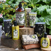 Collection of Lemongrass & Lime themed products on a wooden surface with greenery in the background.