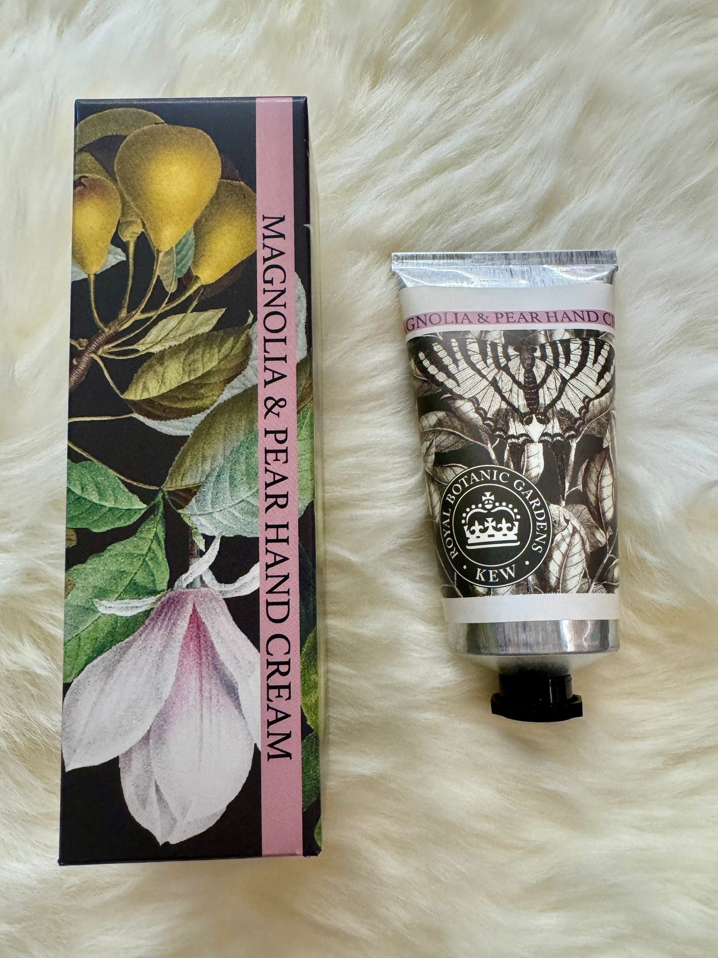 Hand cream packaging with floral design on a fluffy white surface