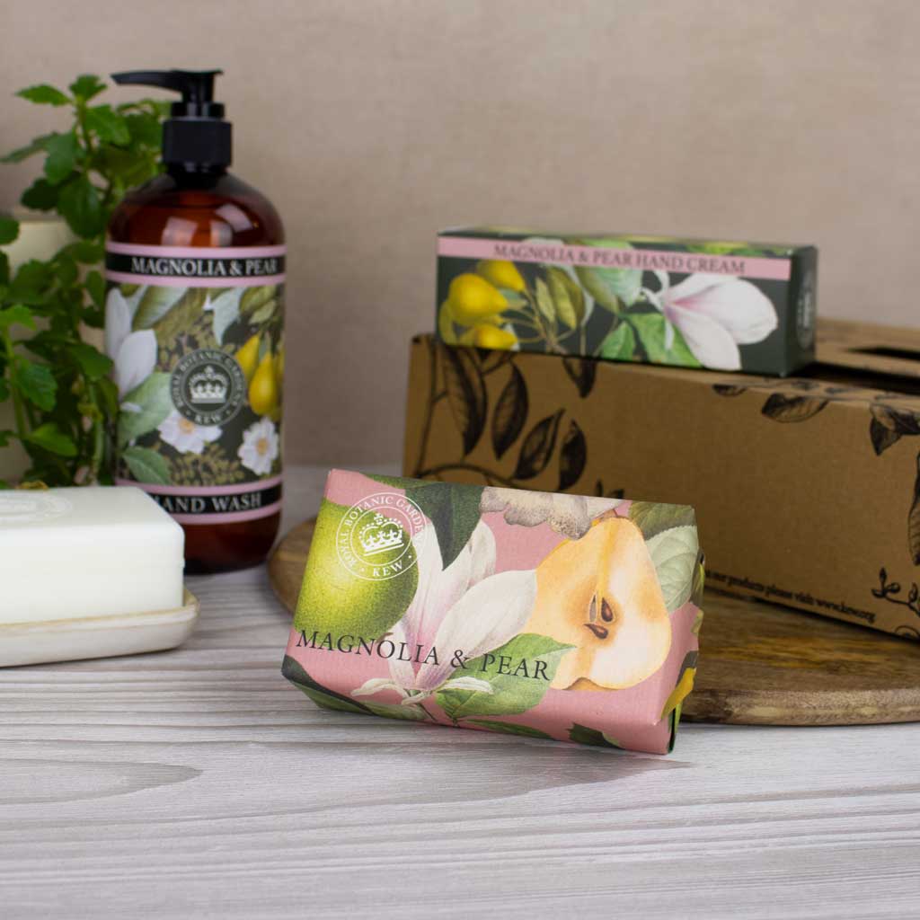 Cosmetic products with 'Magnolia & Pear' branding on a neutral background