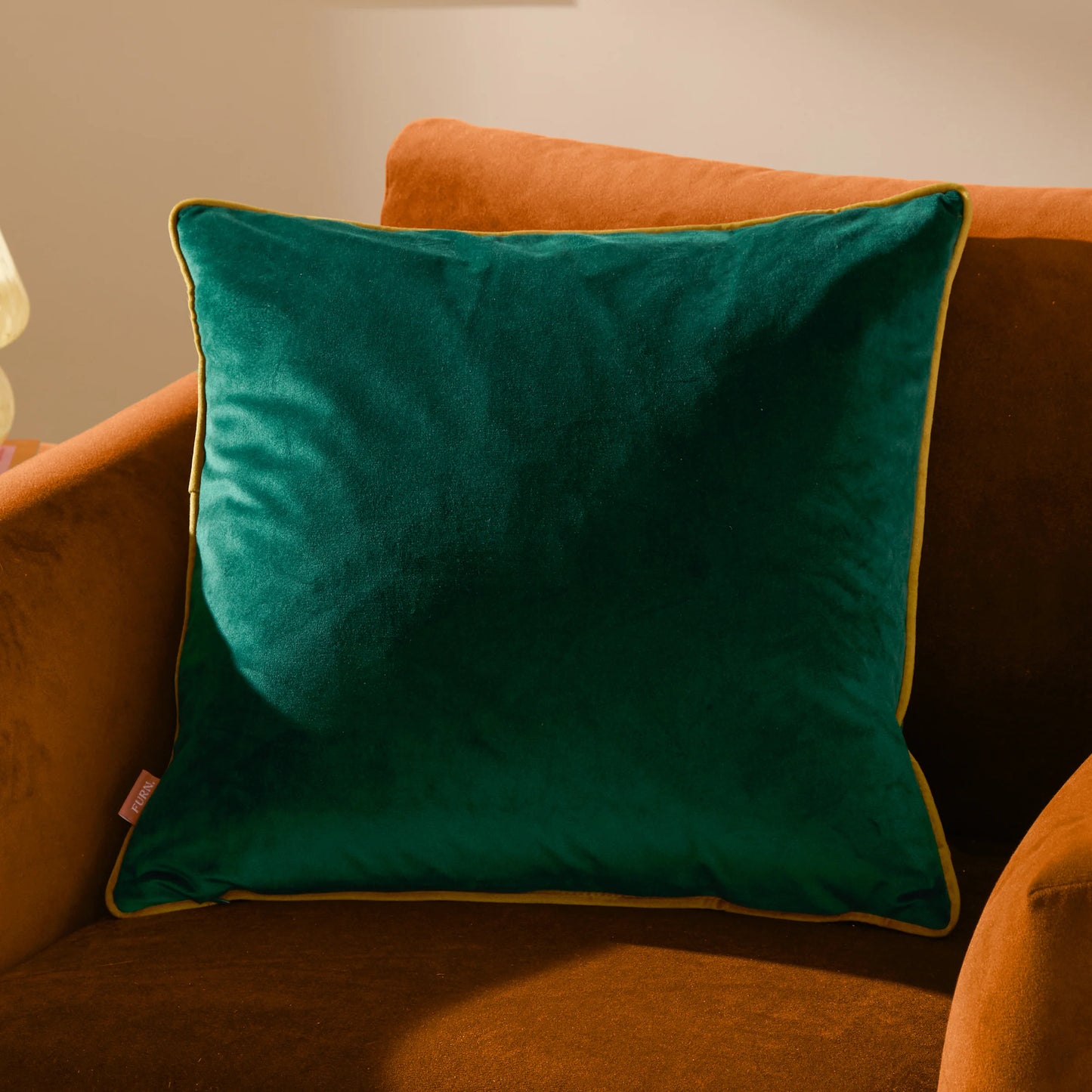 Green pillow on an orange couch