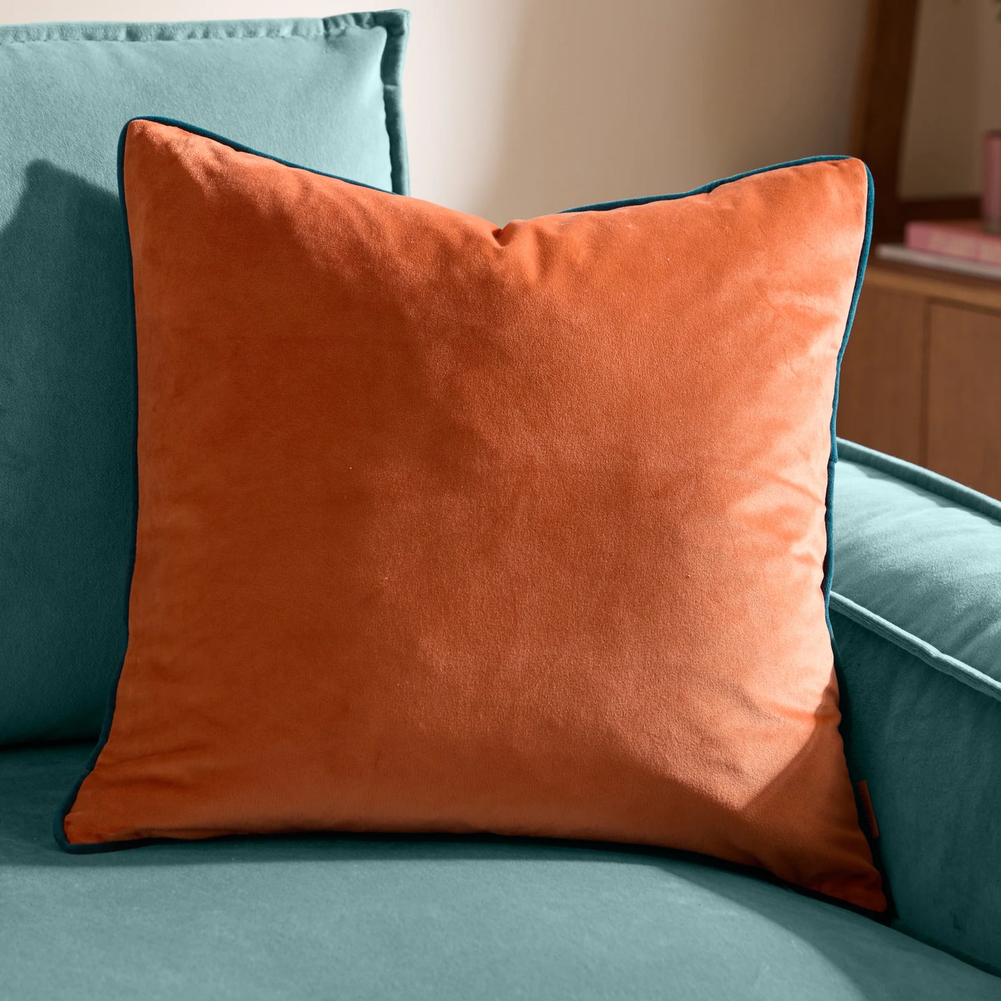 orange cushion on sofa