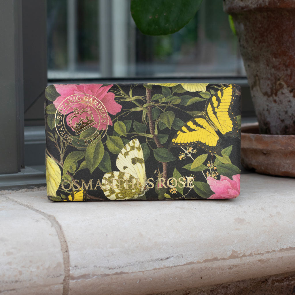 Cosmetic bag with floral and butterfly design on a surface