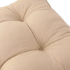 Beige cushion with tufted texture on a white background