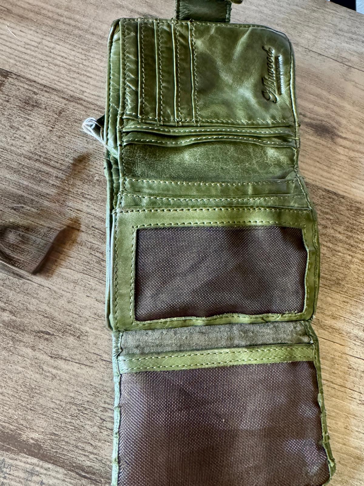 Green tactical pouch on a wooden surface