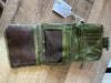 Green wallet with a tag on a wooden surface