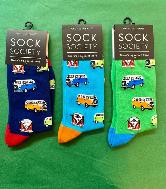 Three pairs of colorful socks with vehicle patterns on a green background, branded as Sock Society.