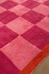 Close-up of a pink and red checkered rug