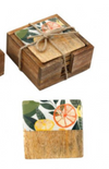 Set of wooden coasters with floral and fruit design in a box